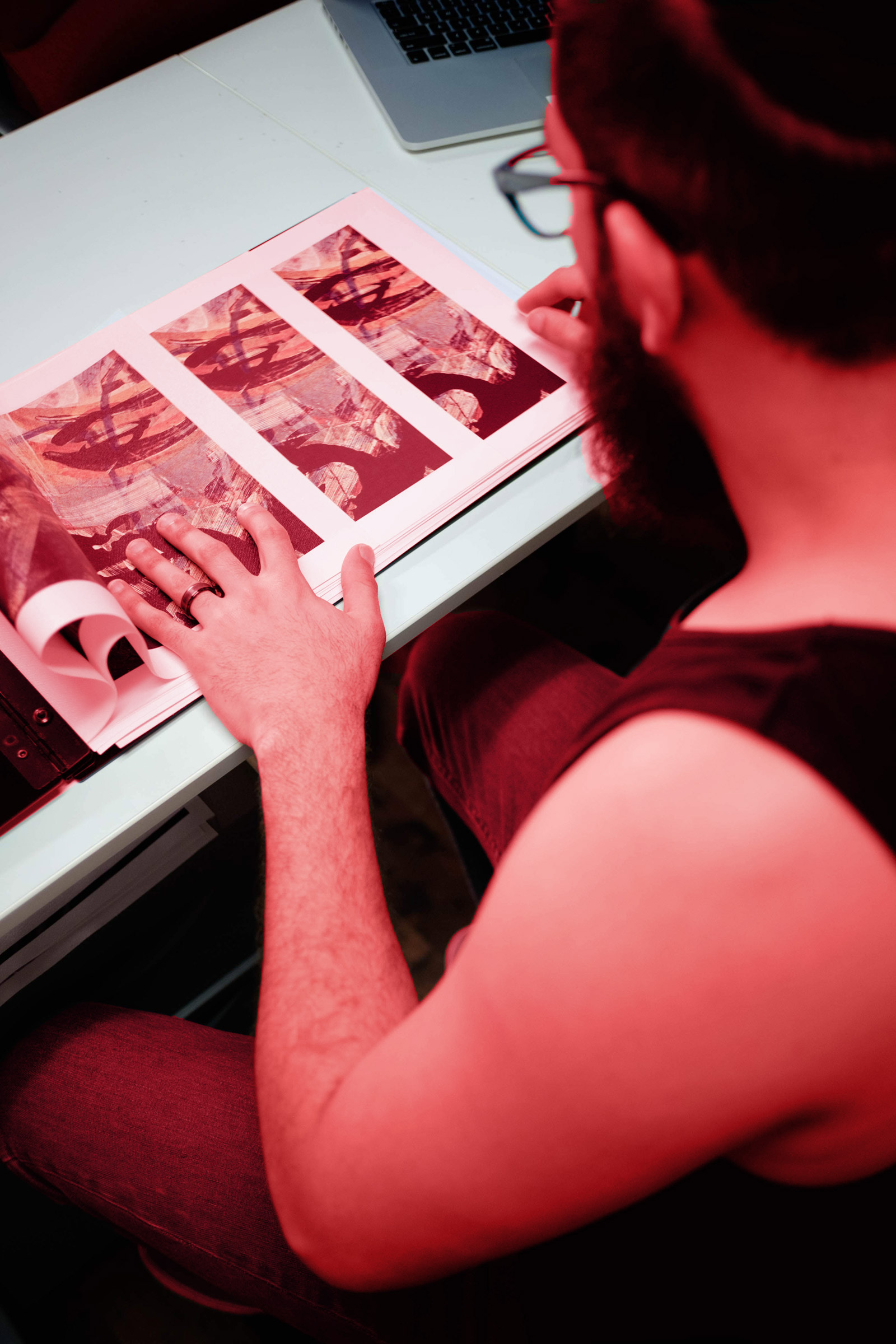A person reviewing a photo file by hand