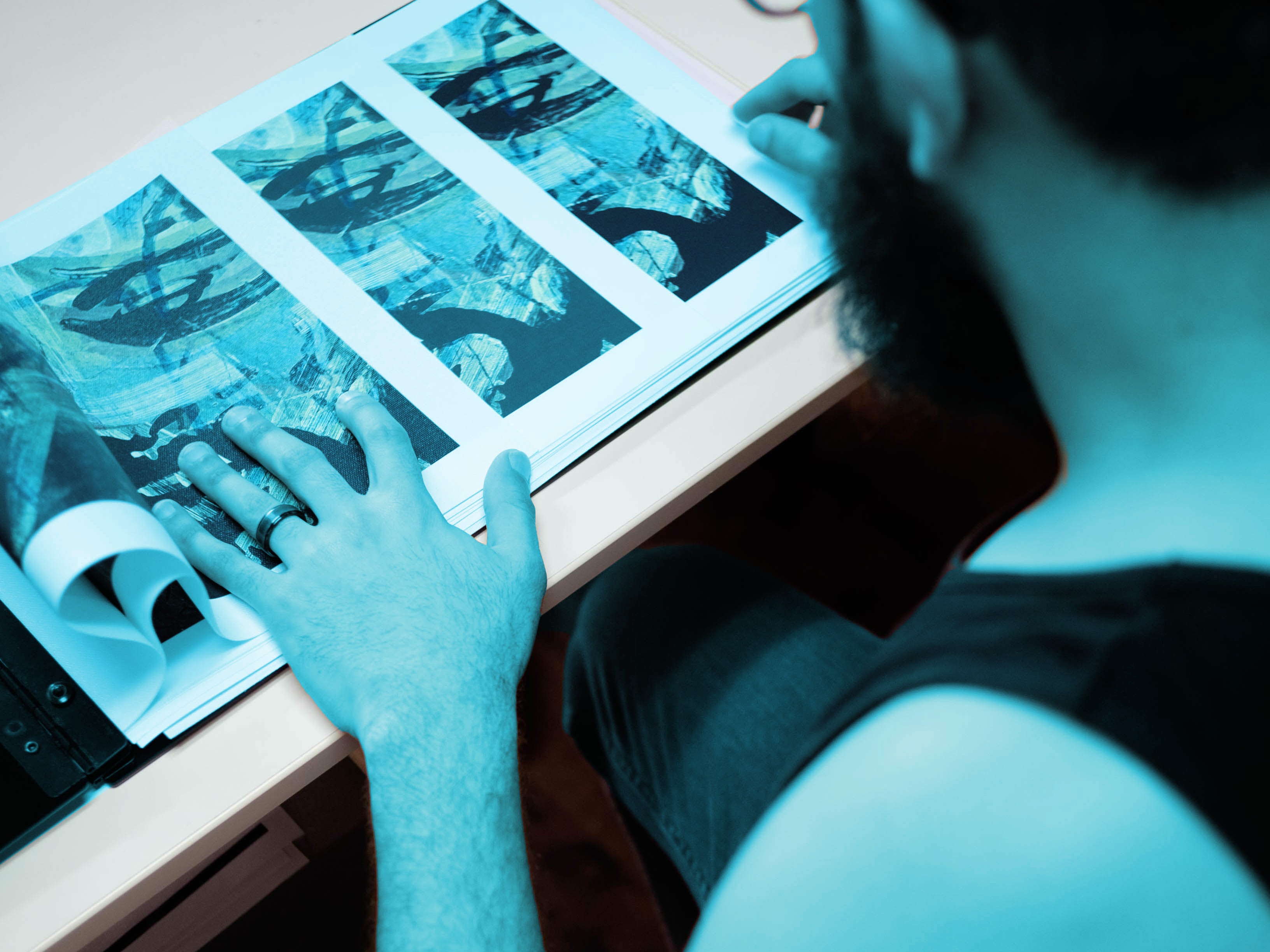 A person reviewing a photo file by hand