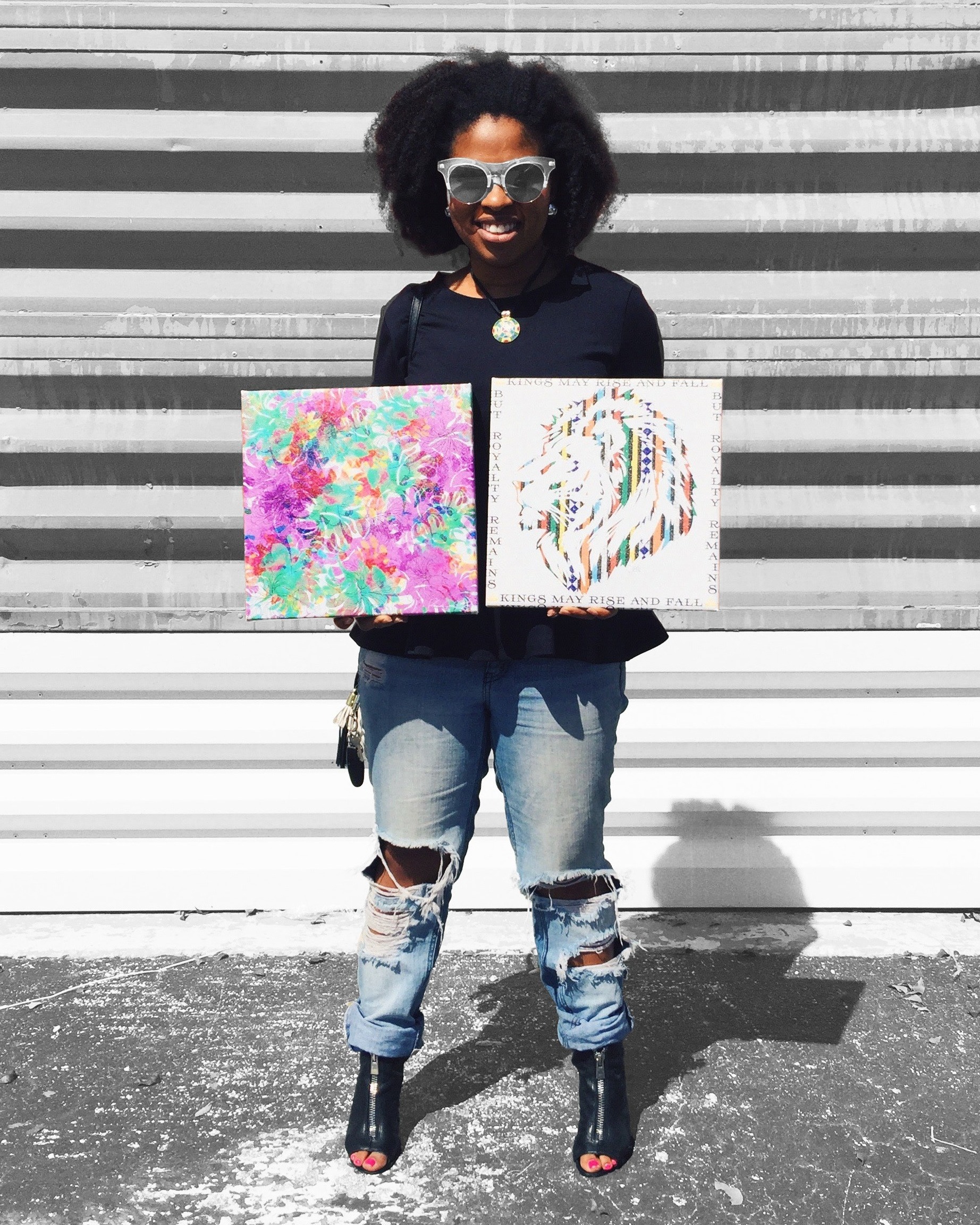 Pro Account Artist Jasmin holding two 12x12 Canvas prints.